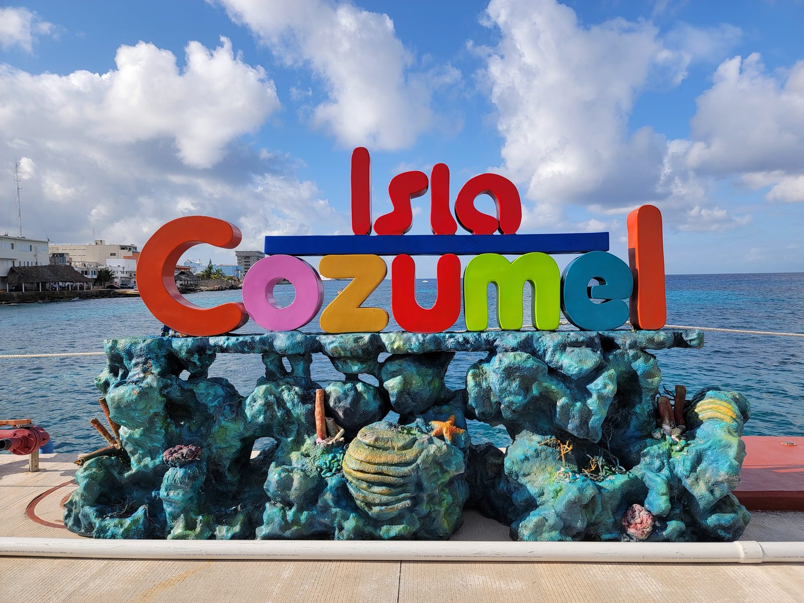 The Isla Cozumel sign at the pier