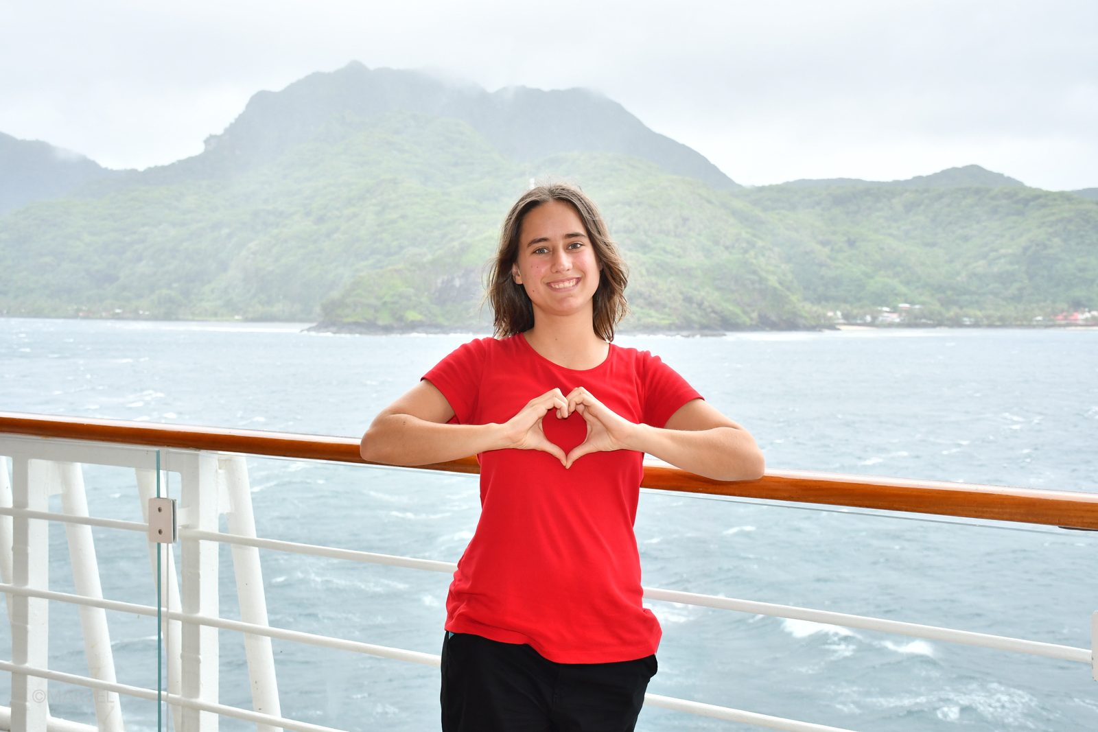 Lisa making a heart on deck in Pago Pago