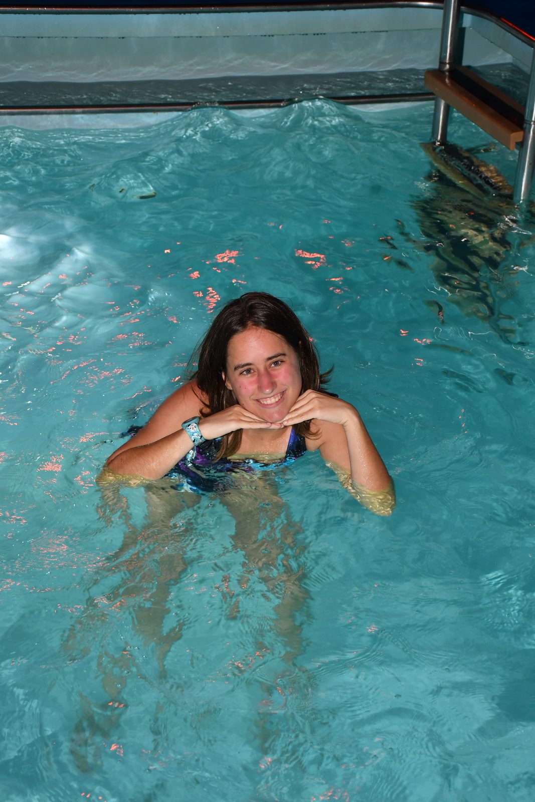 Lisa swimming in the night pool