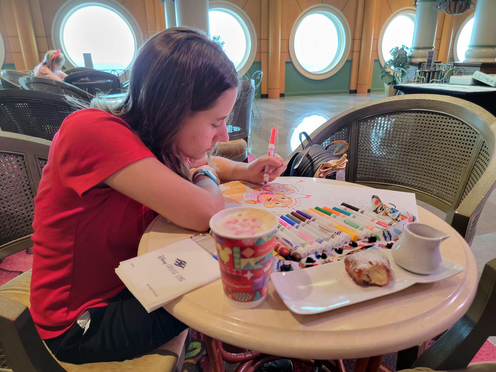 Lisa coloring over breakfast