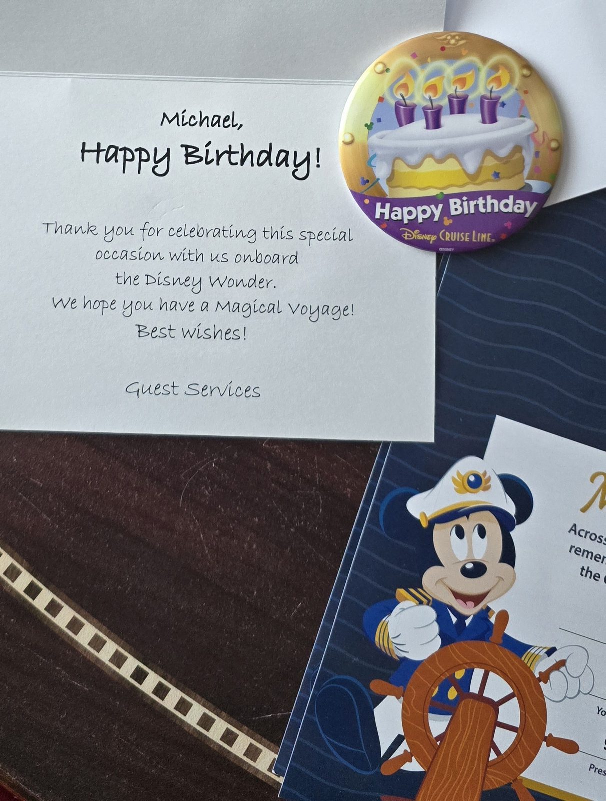 A birthday note and pin from Guest Services