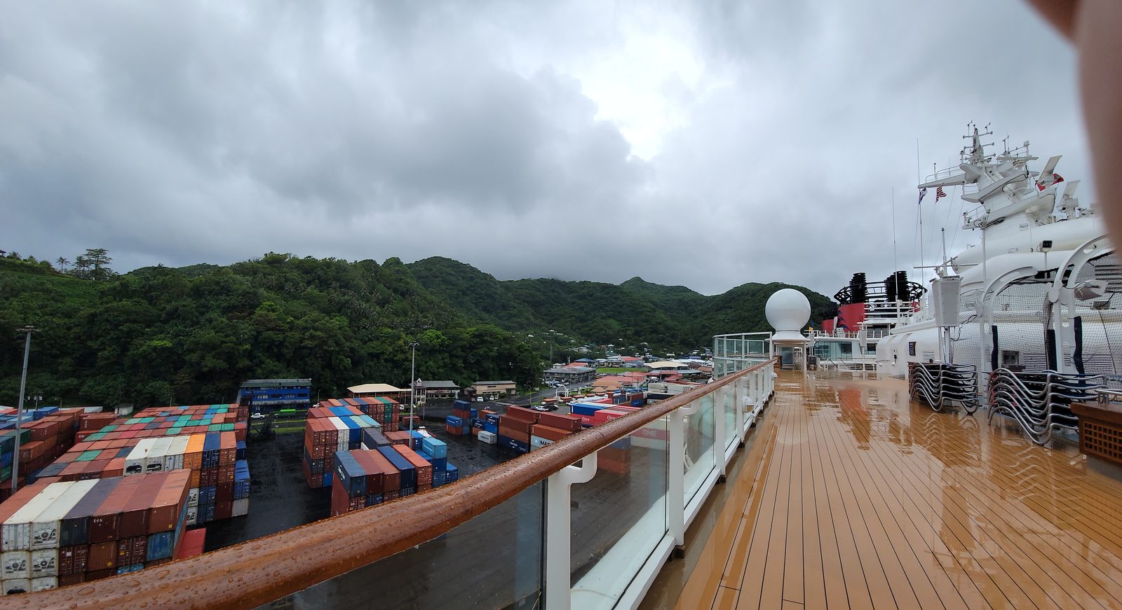 The Wonder eases past Pago Pago's container harbor