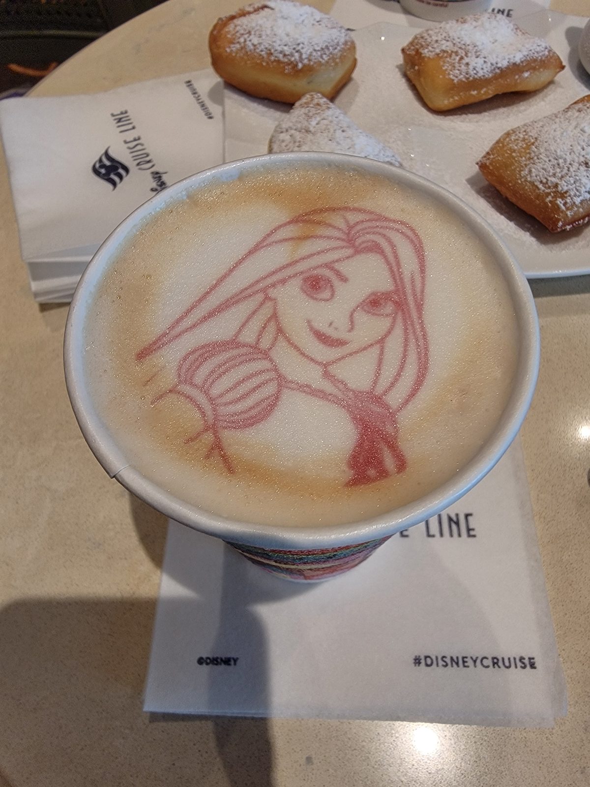 Ariel drawn in the coffee foam