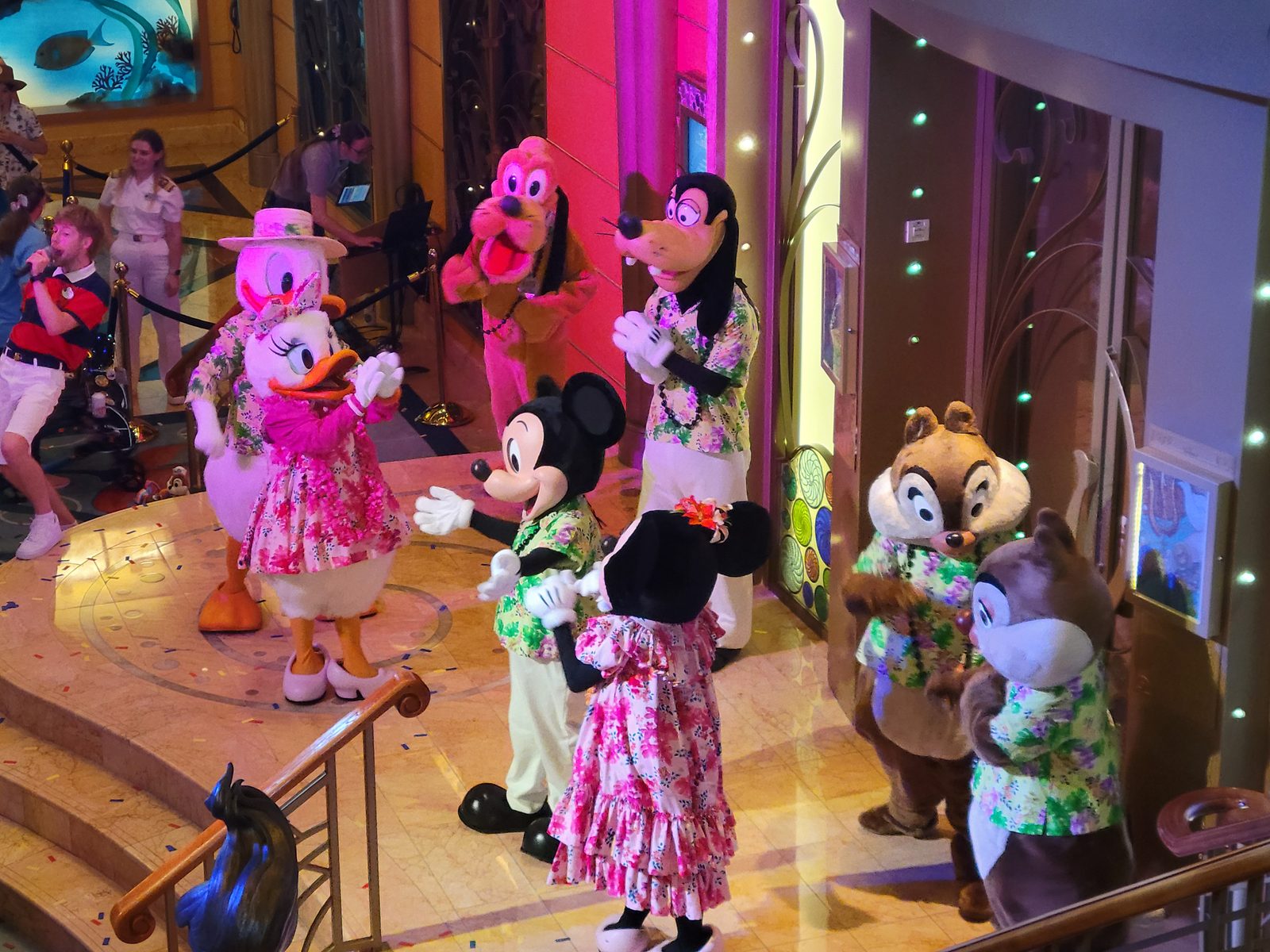 Mickey, Minnie, Daisy, Goofy, Pluto, Chip & Dale dance in aloha wear in the Lobby Atrium