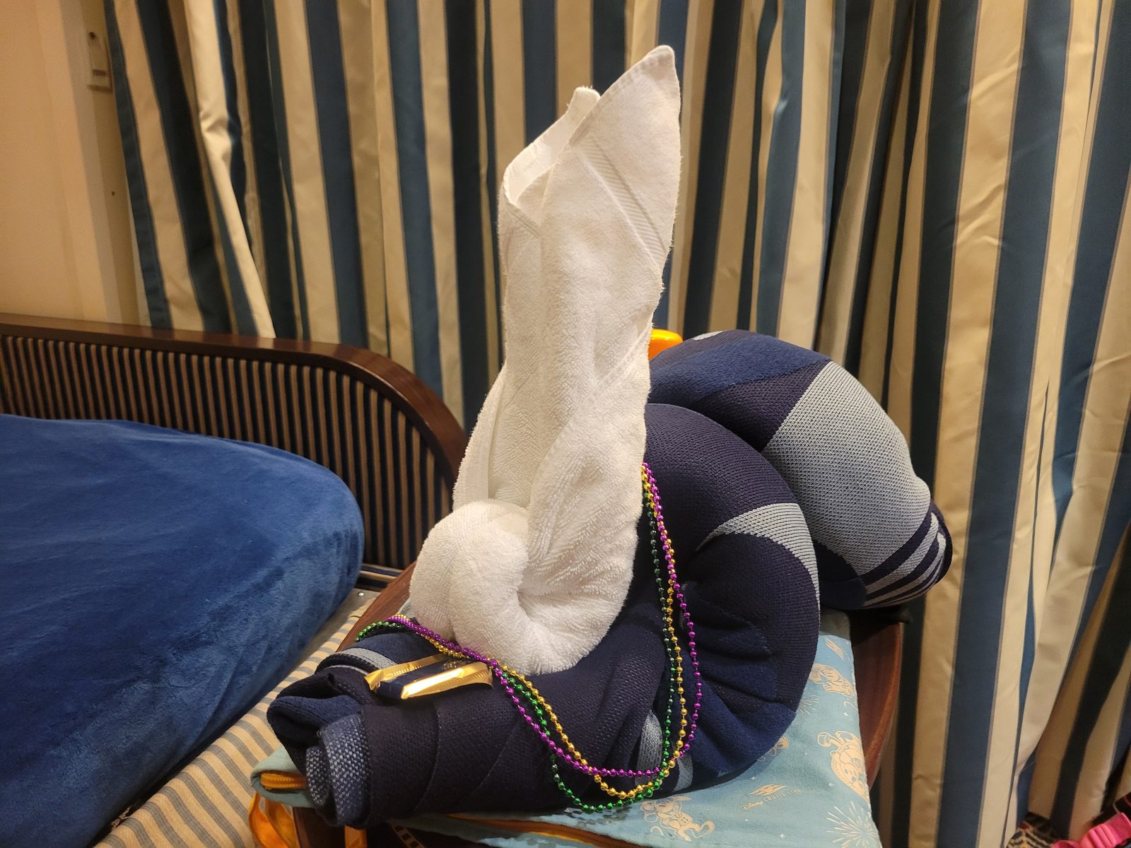 A rabbit towel animal on the bed