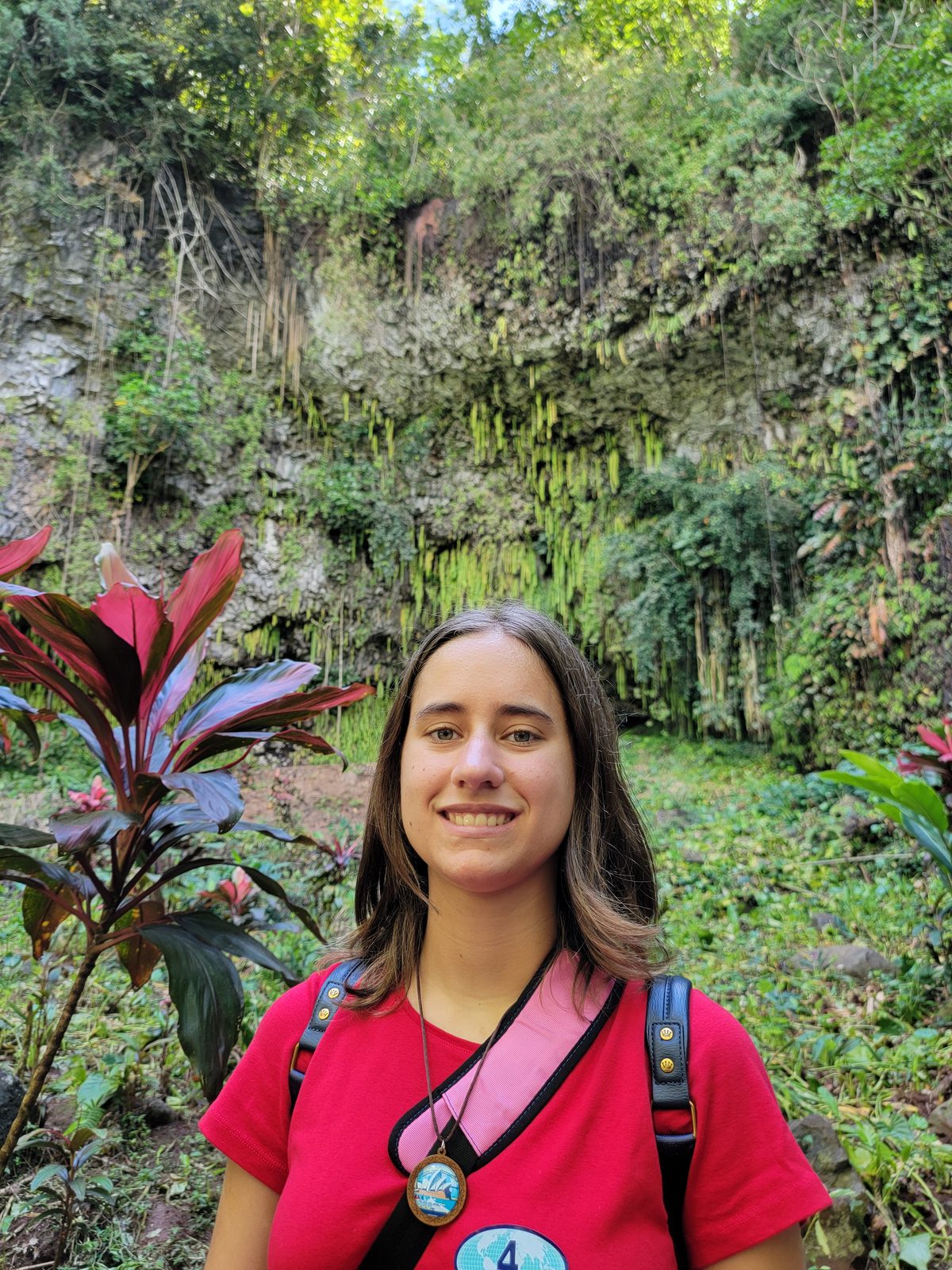 Lisa among the red ti plants at the Fern Grotto