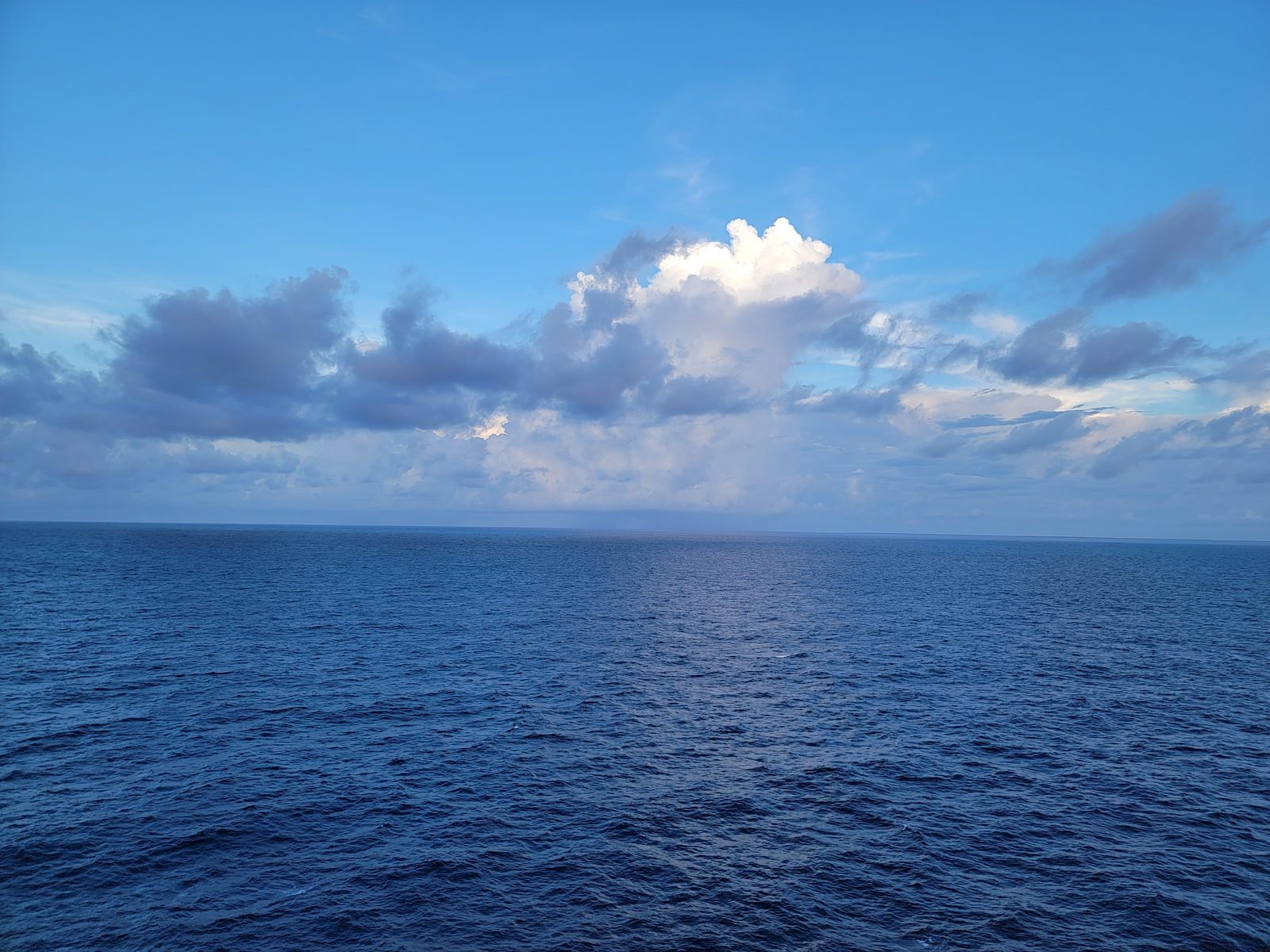 Clouds catching the last light over the water
