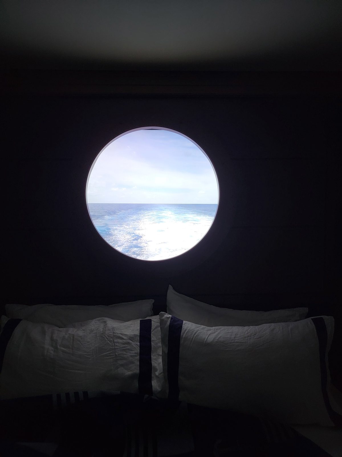 Just the porthole glowing in the dark stateroom