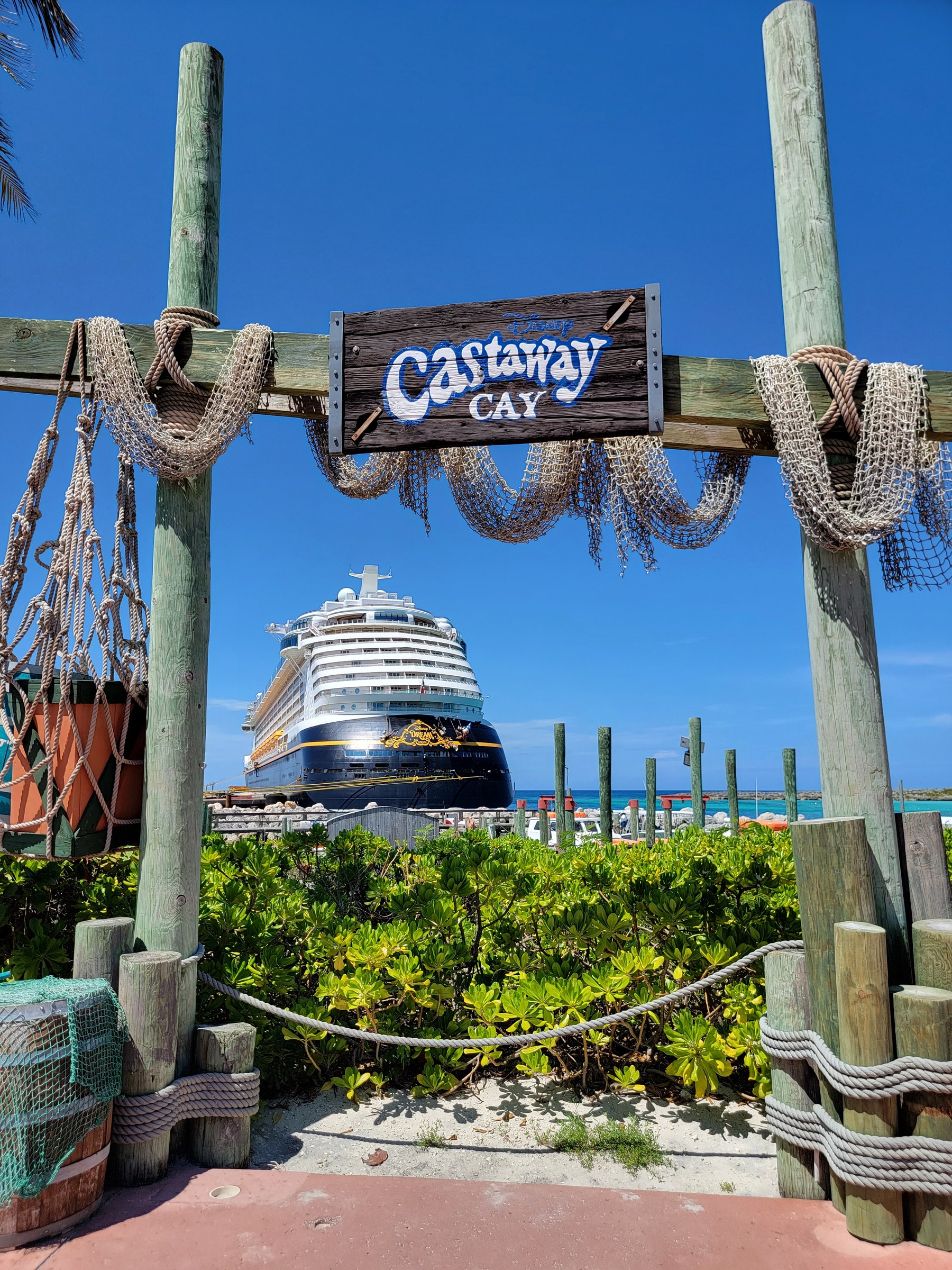 The Castaway Cay sign, with the Dream behind it
