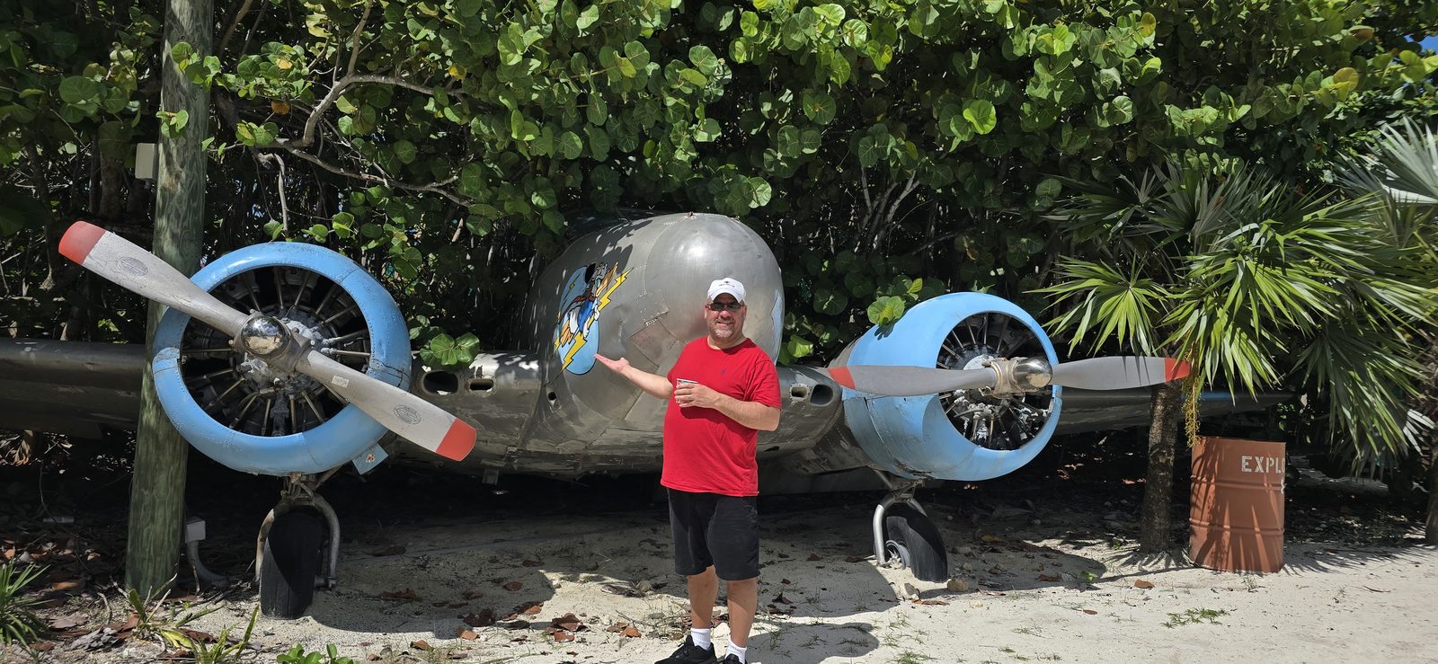 Posing by the beached biplane