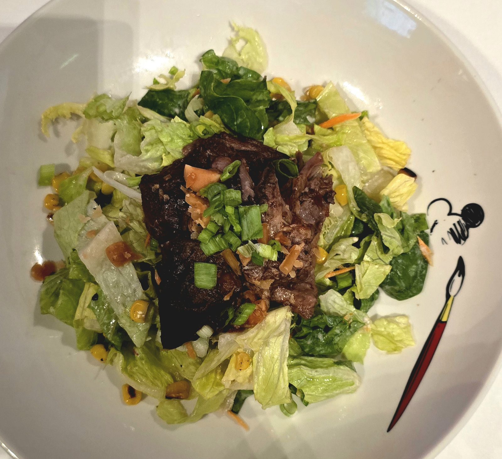 Salad topped with a Mickey pick