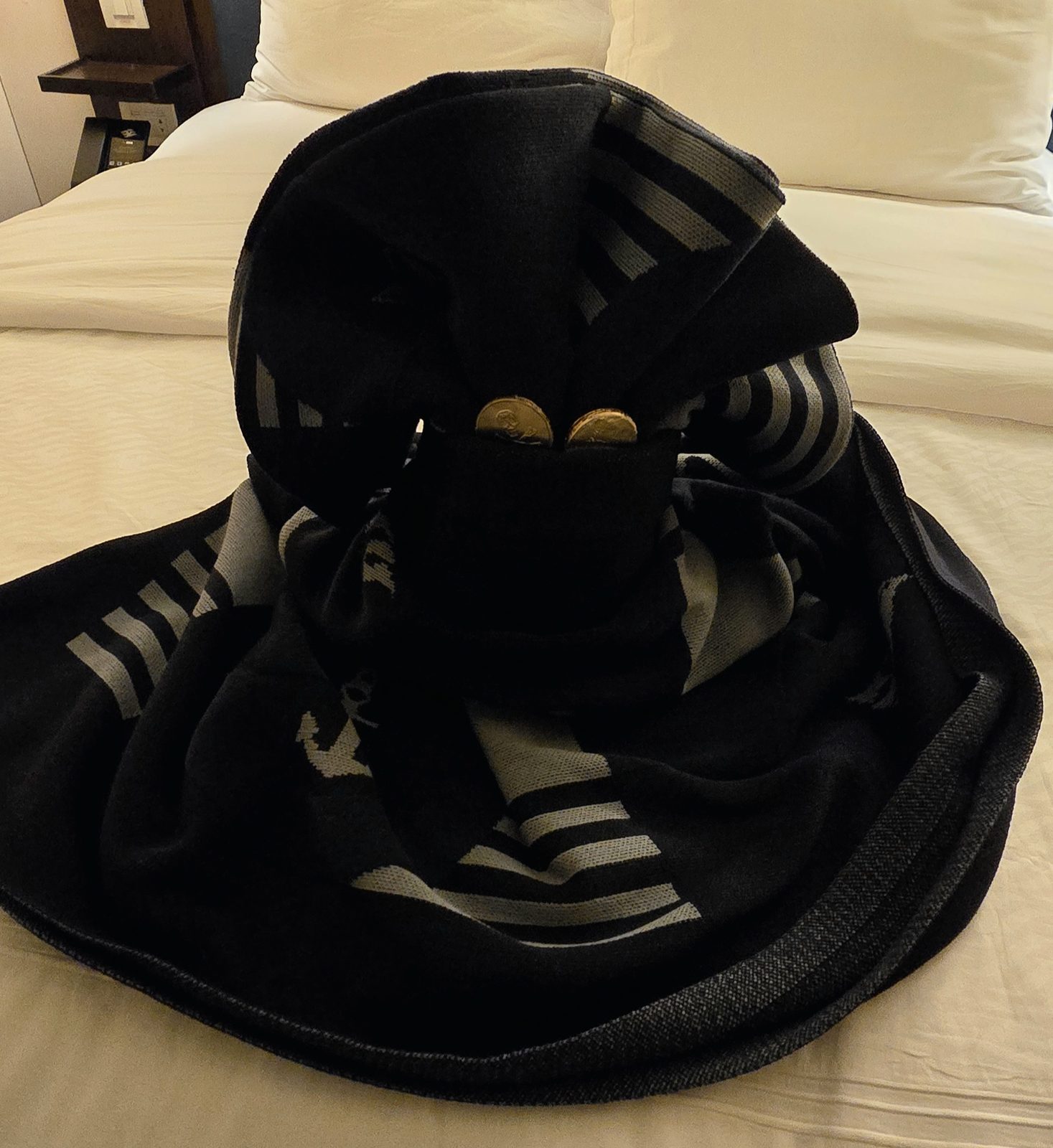 A pirate hat towel animal on the bed