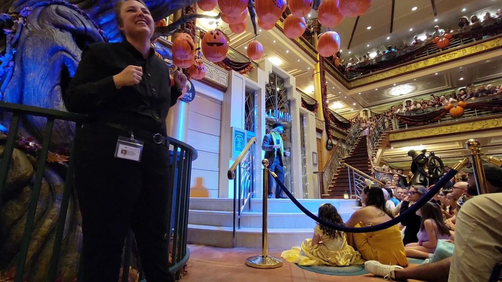 An ASL interpreter signing the Halloween show in the atrium