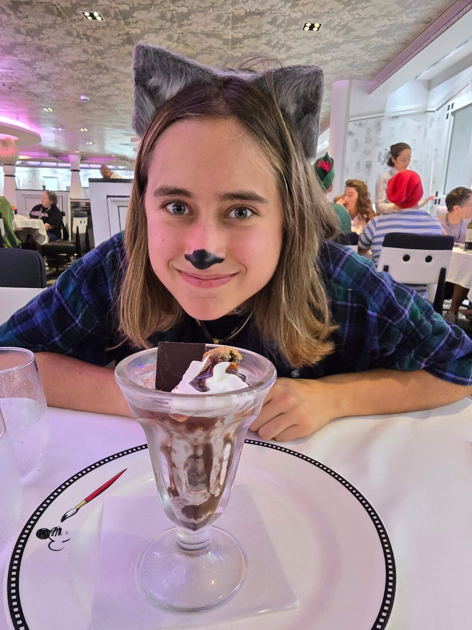 Lisa in her cat face paint with a sundae at Animator's Palate