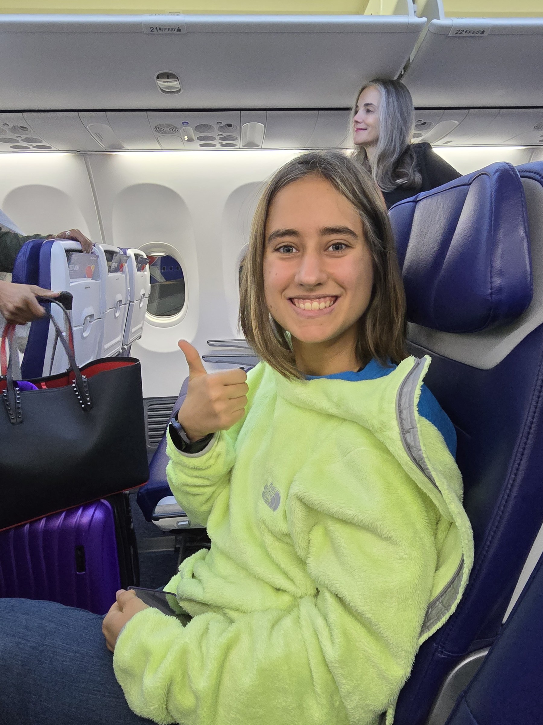 Lisa, thumbs up, on the early flight
