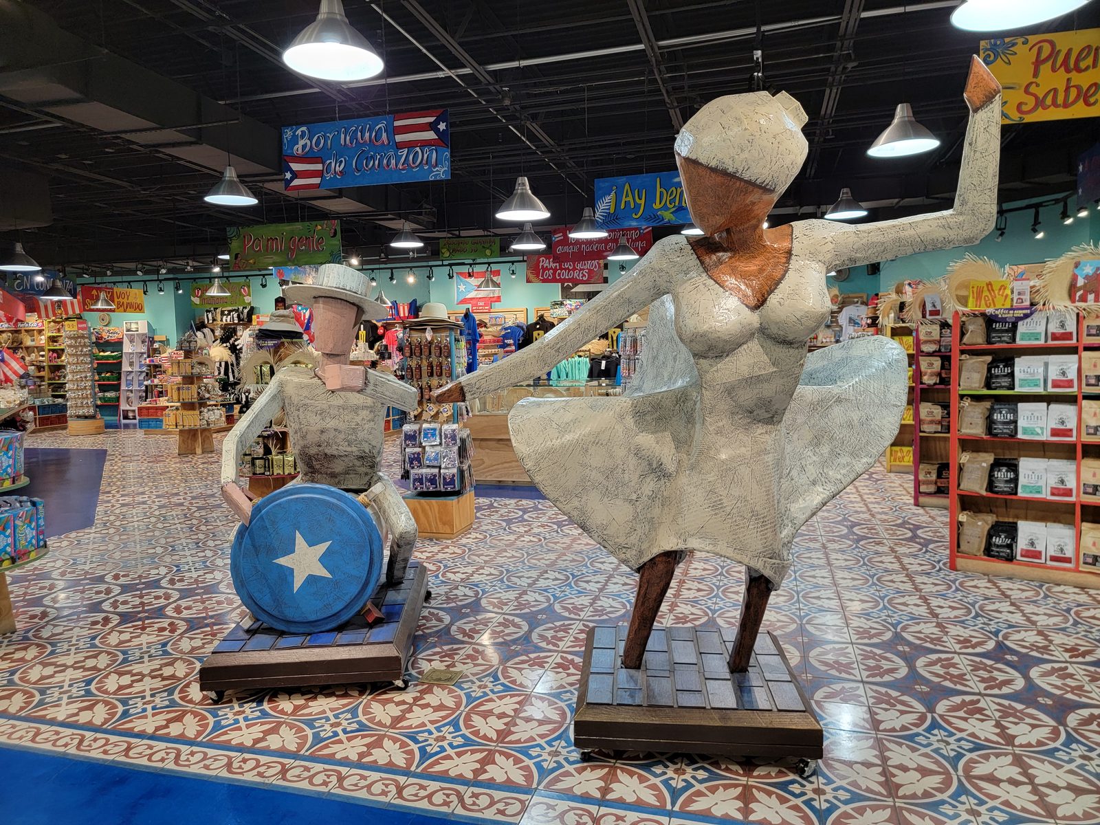 A salsa dancer statue greets shoppers at El Market, in the San Juan airport