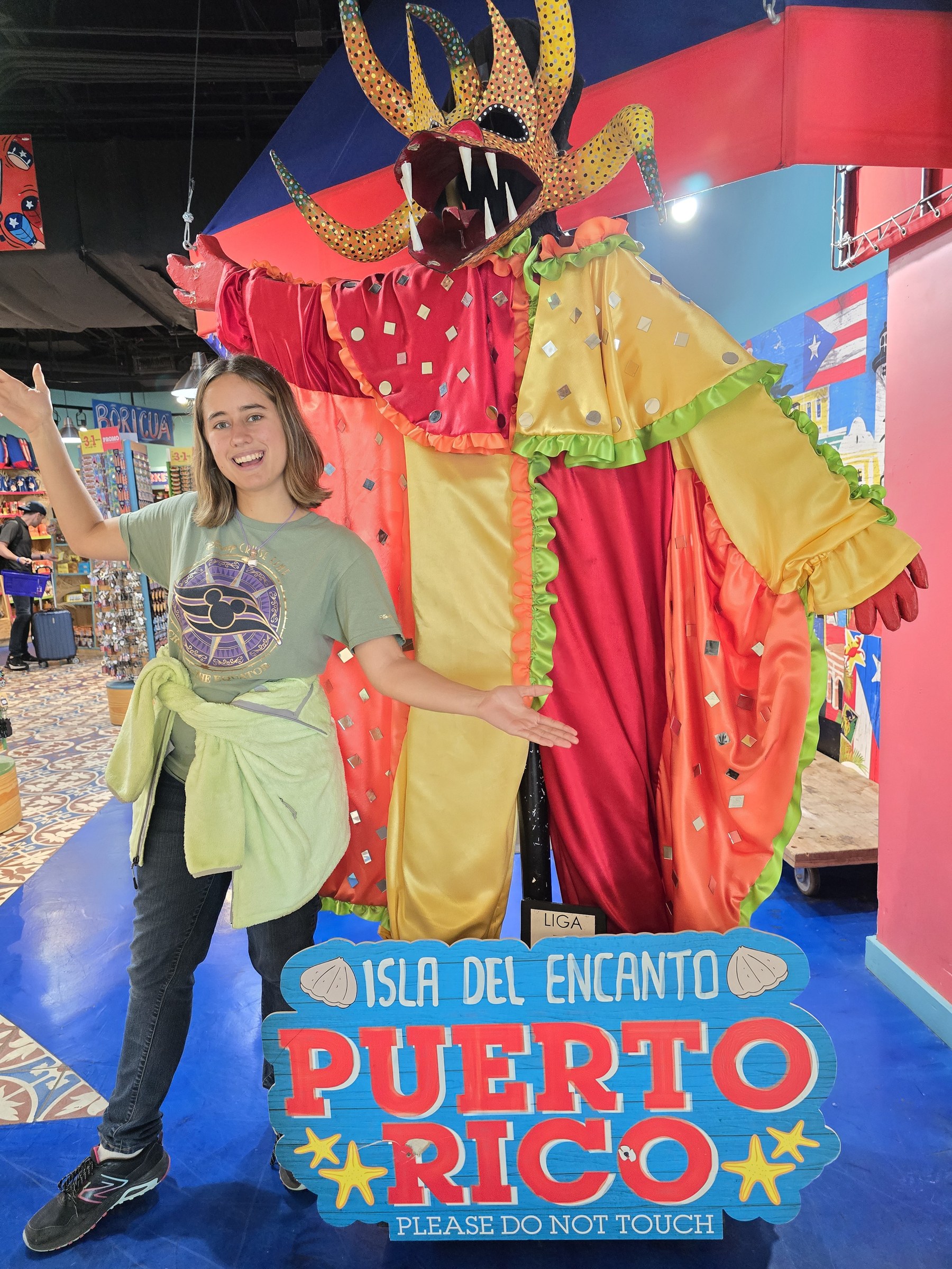 Lisa beside the vejigante carnival costume at the San Juan airport