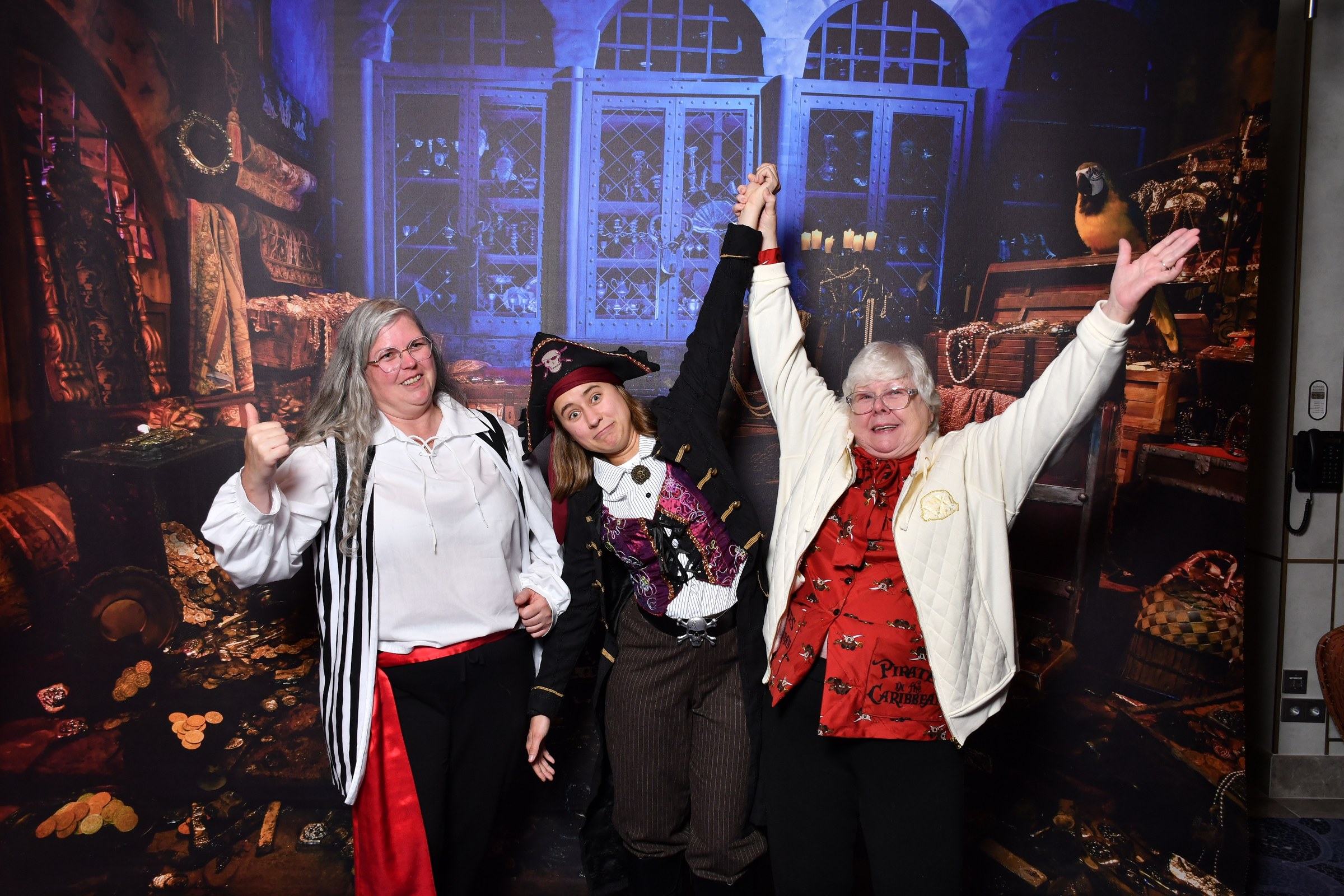 Julie, Lisa and Donna celebrate at the treasure backdrop on Pirate Night