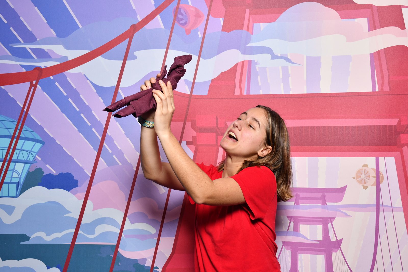 Lisa play fighting with a plush at the photo wall