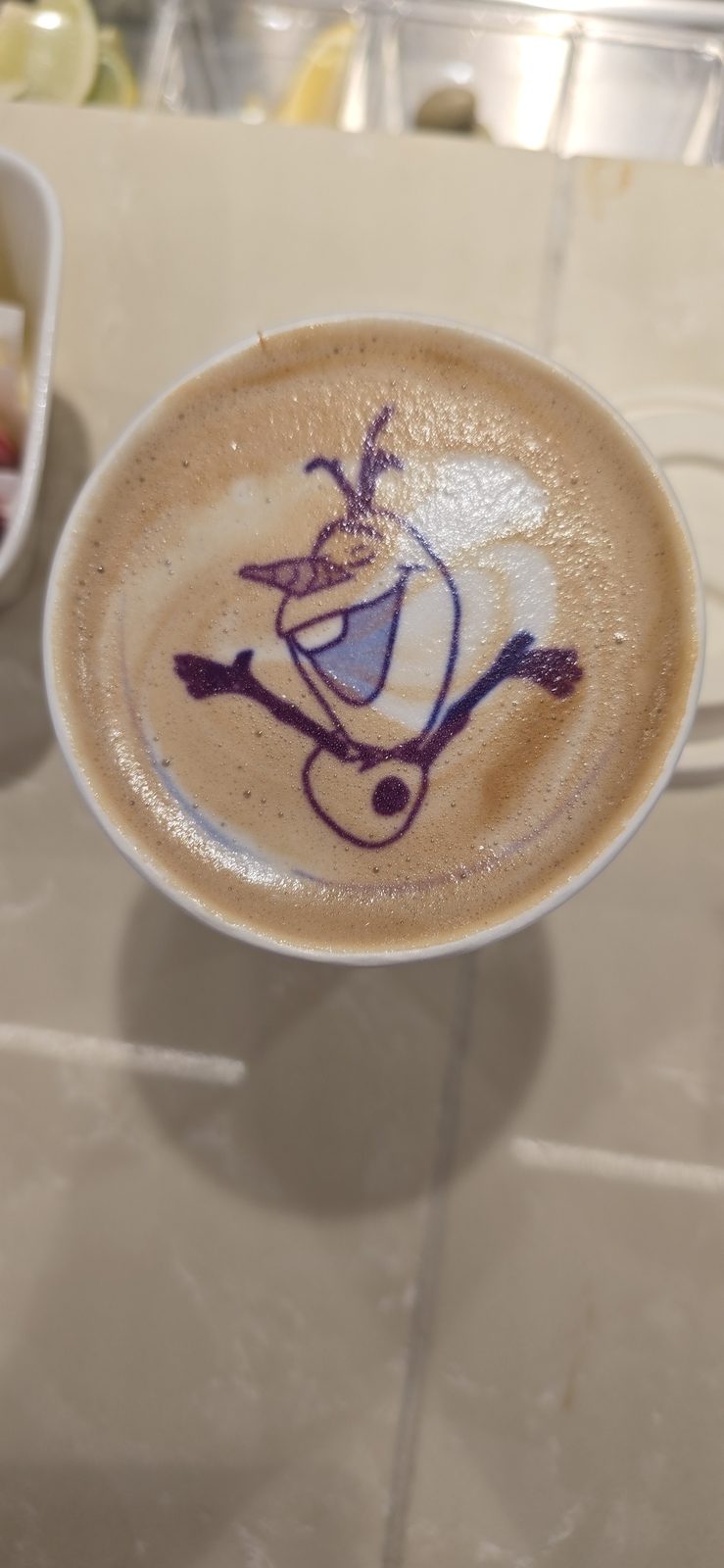 Olaf-face latte art at the coffee bar