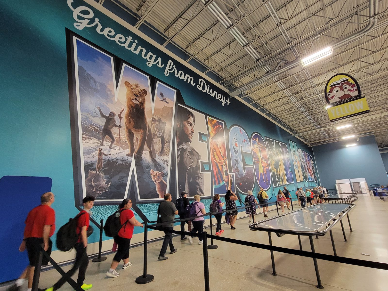 Walking in under the Disney+ mural to check in