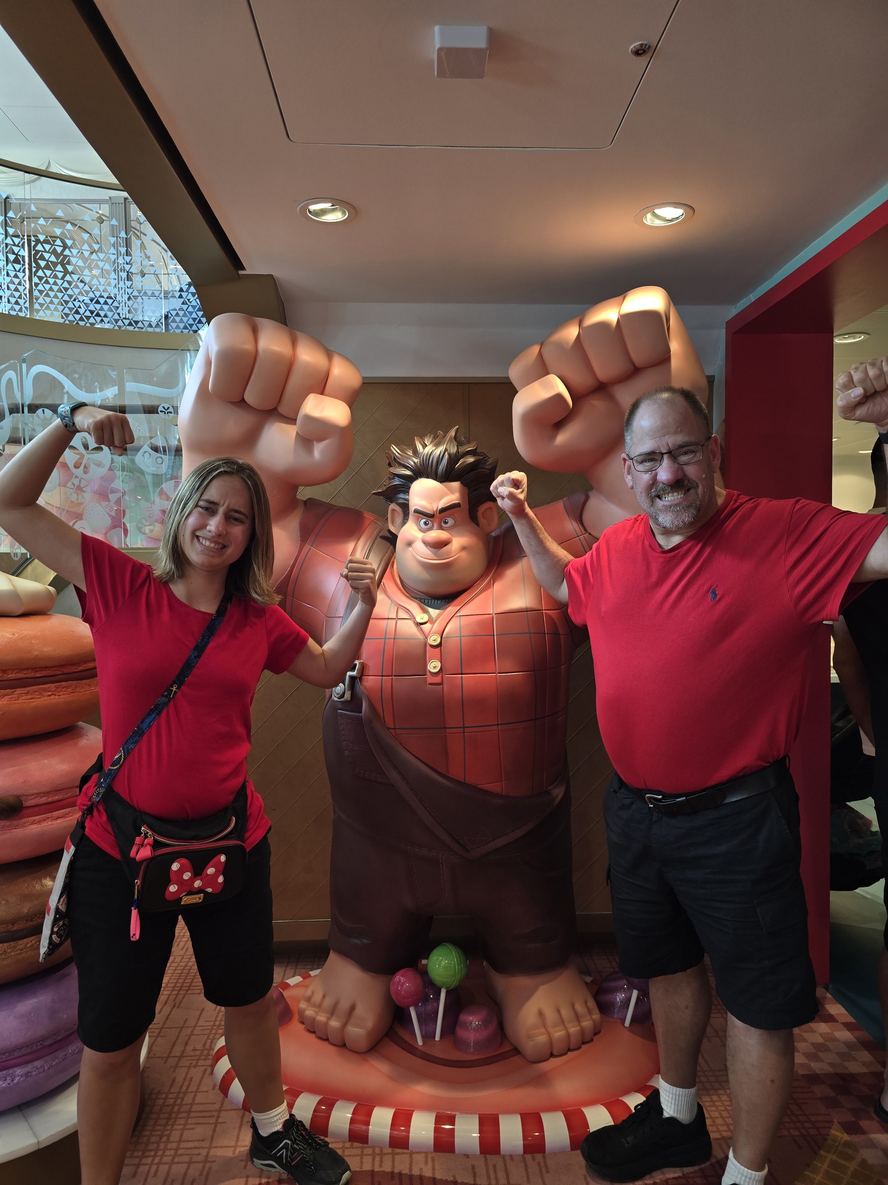 Lisa and Michael flexing with Wreck-It Ralph at the sweet shop