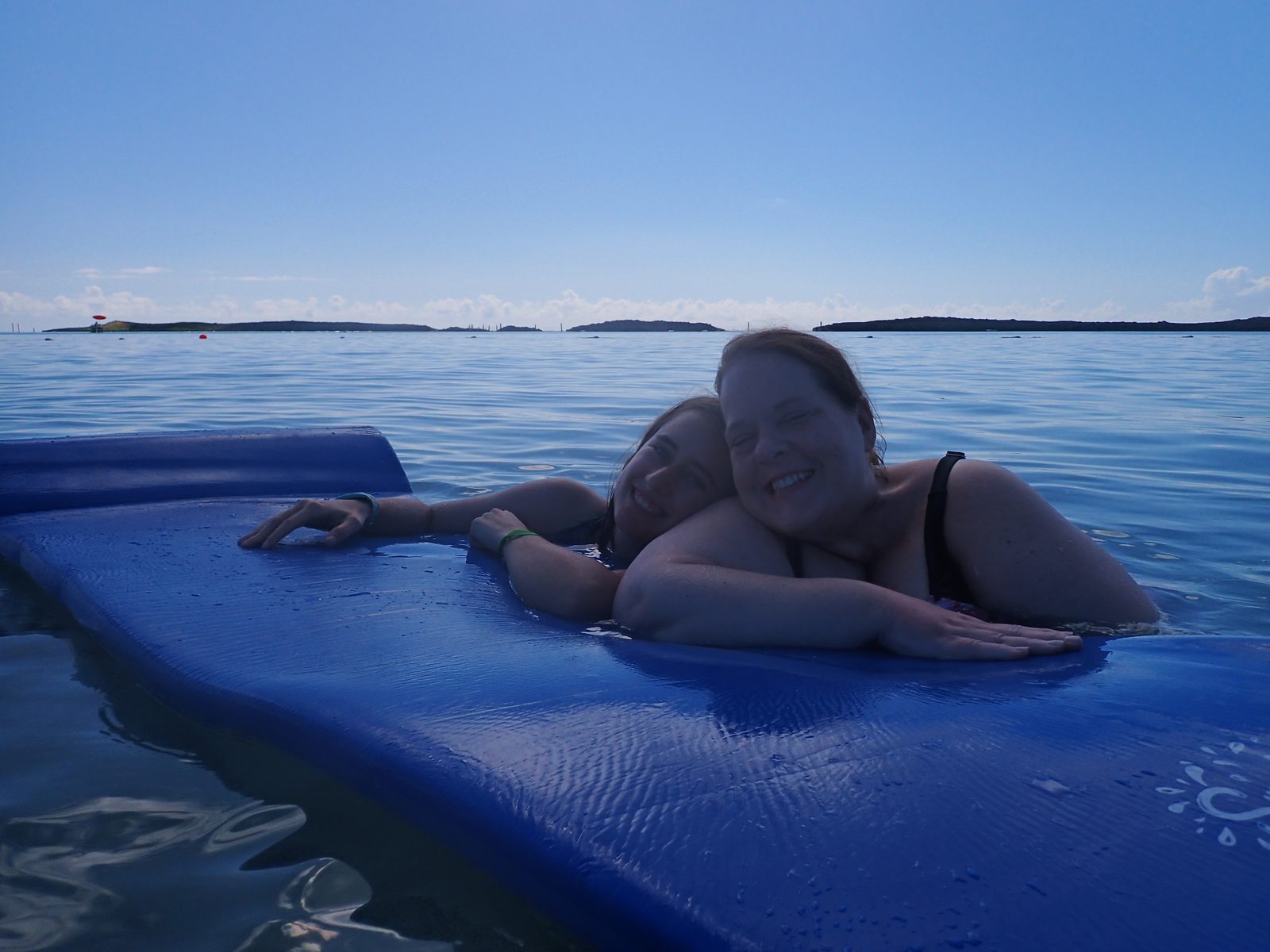 Floating on foam mats in the lagoon