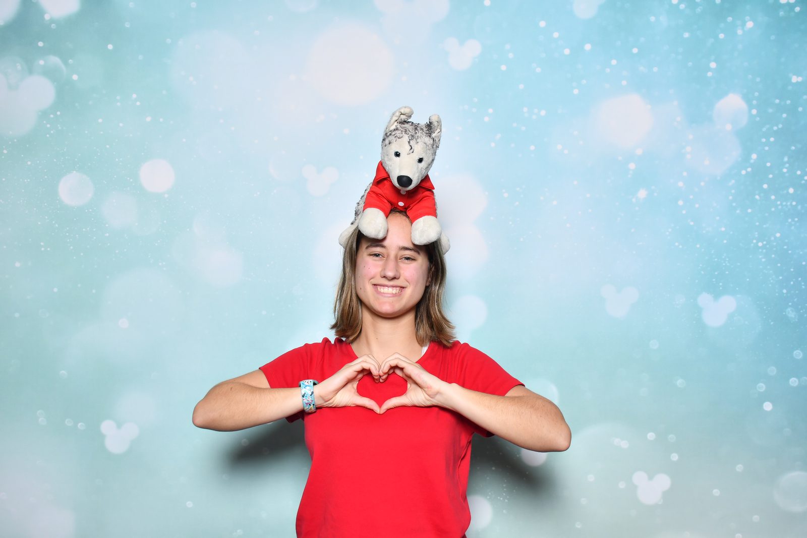 Lisa makes a heart with Bob on her head