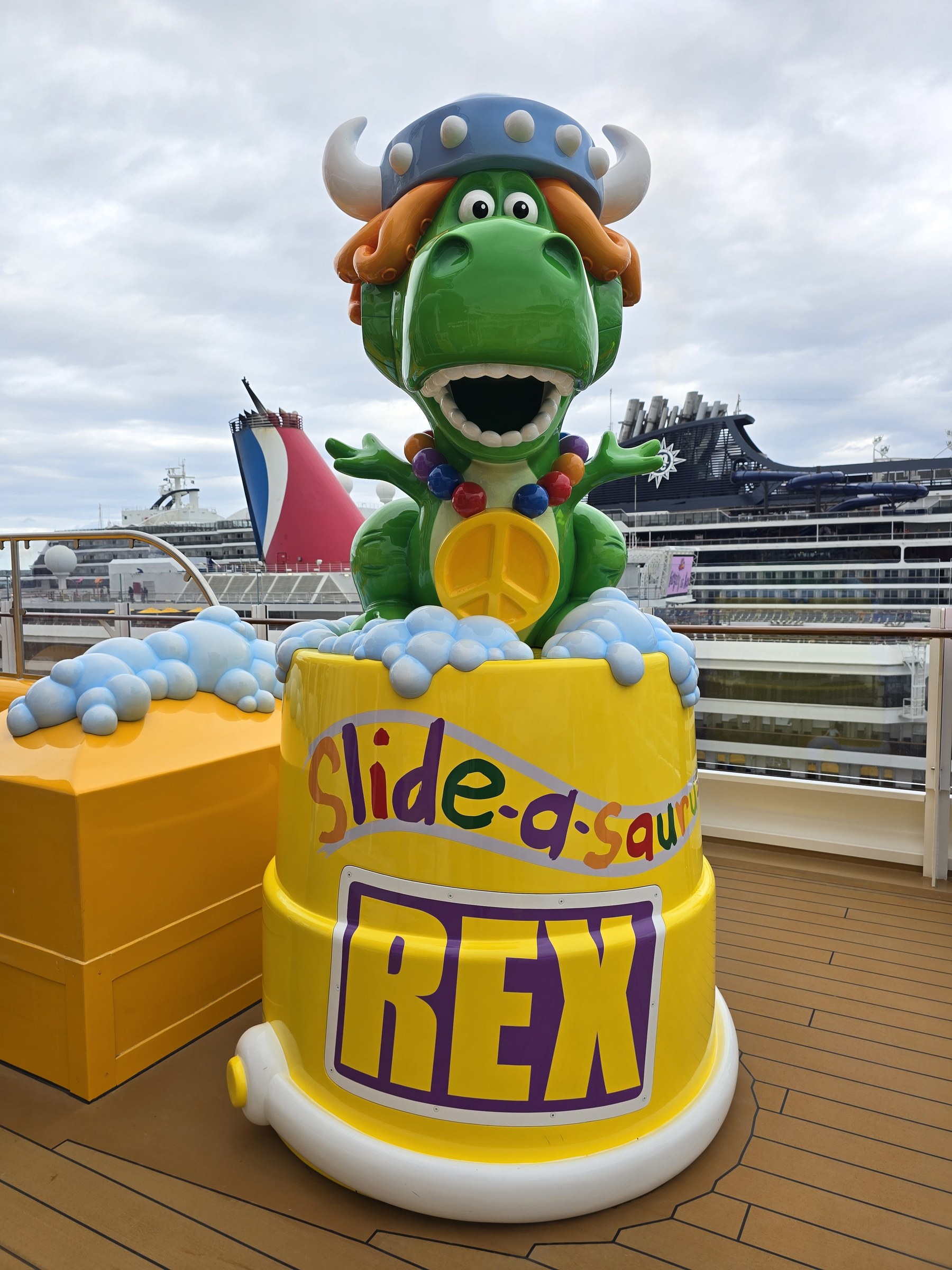 Rex at the Slide-a-saurus on the pool deck