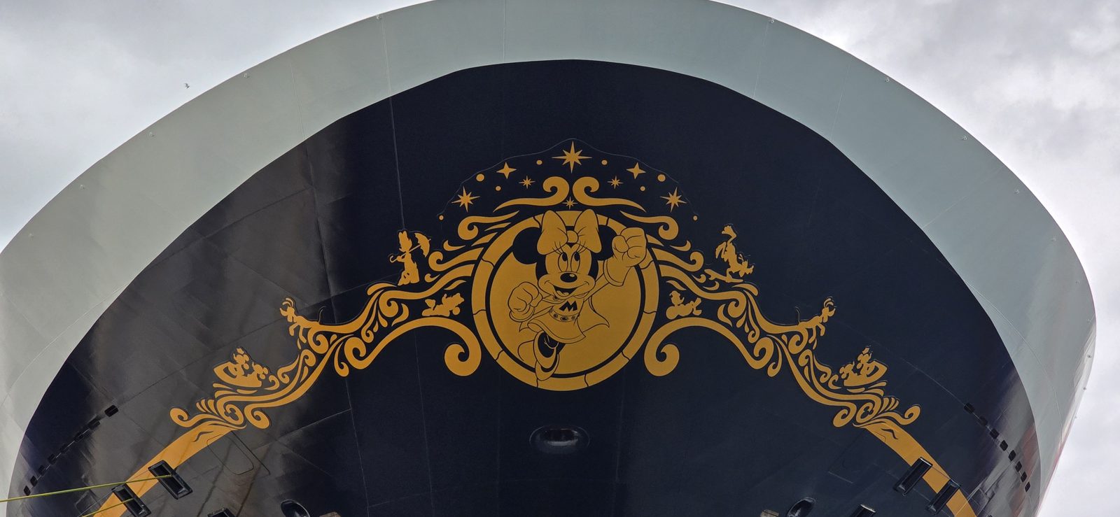 The gold emblem on the Disney Destiny's bow at Nassau