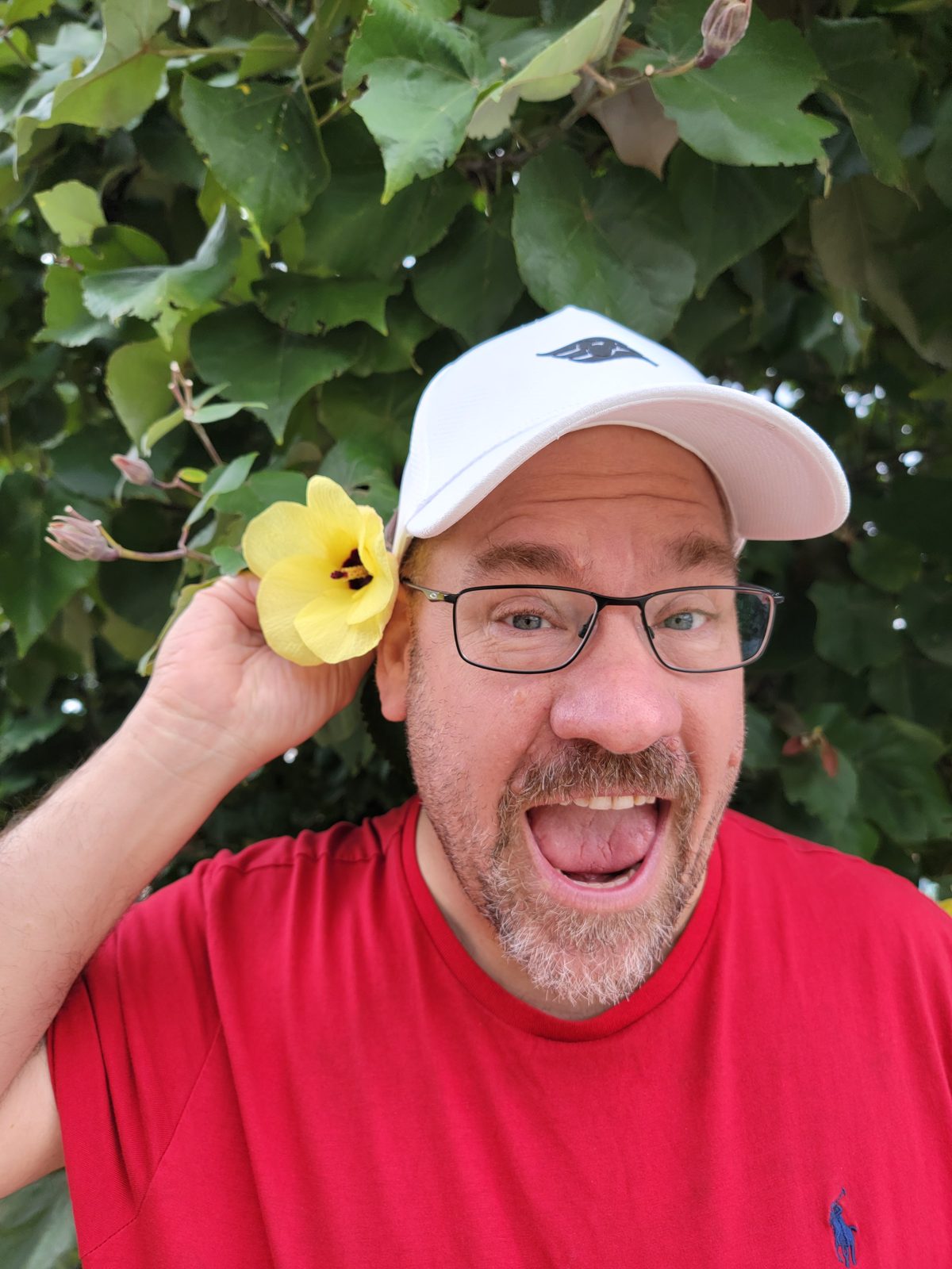 Michael clowning around with a flower on the trail