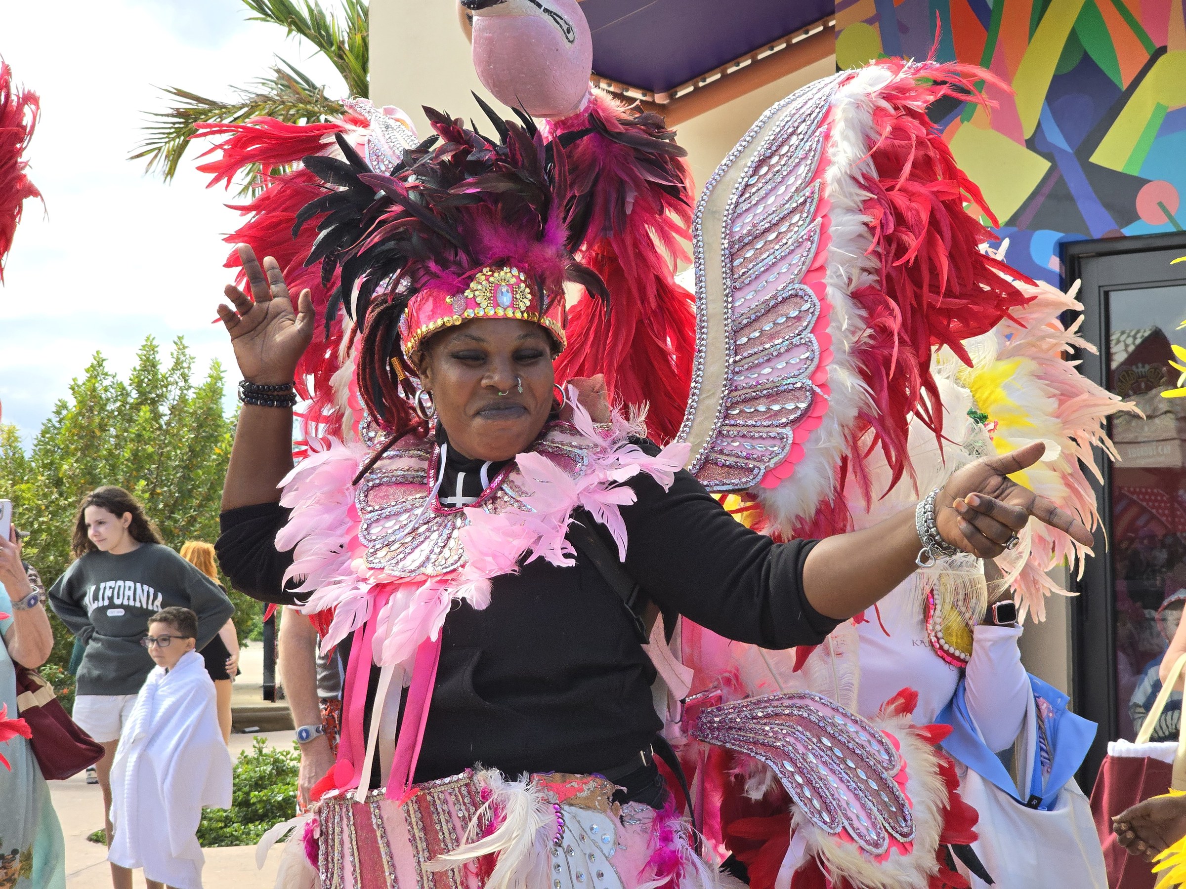 A Junkanoo dancer in pink feathers