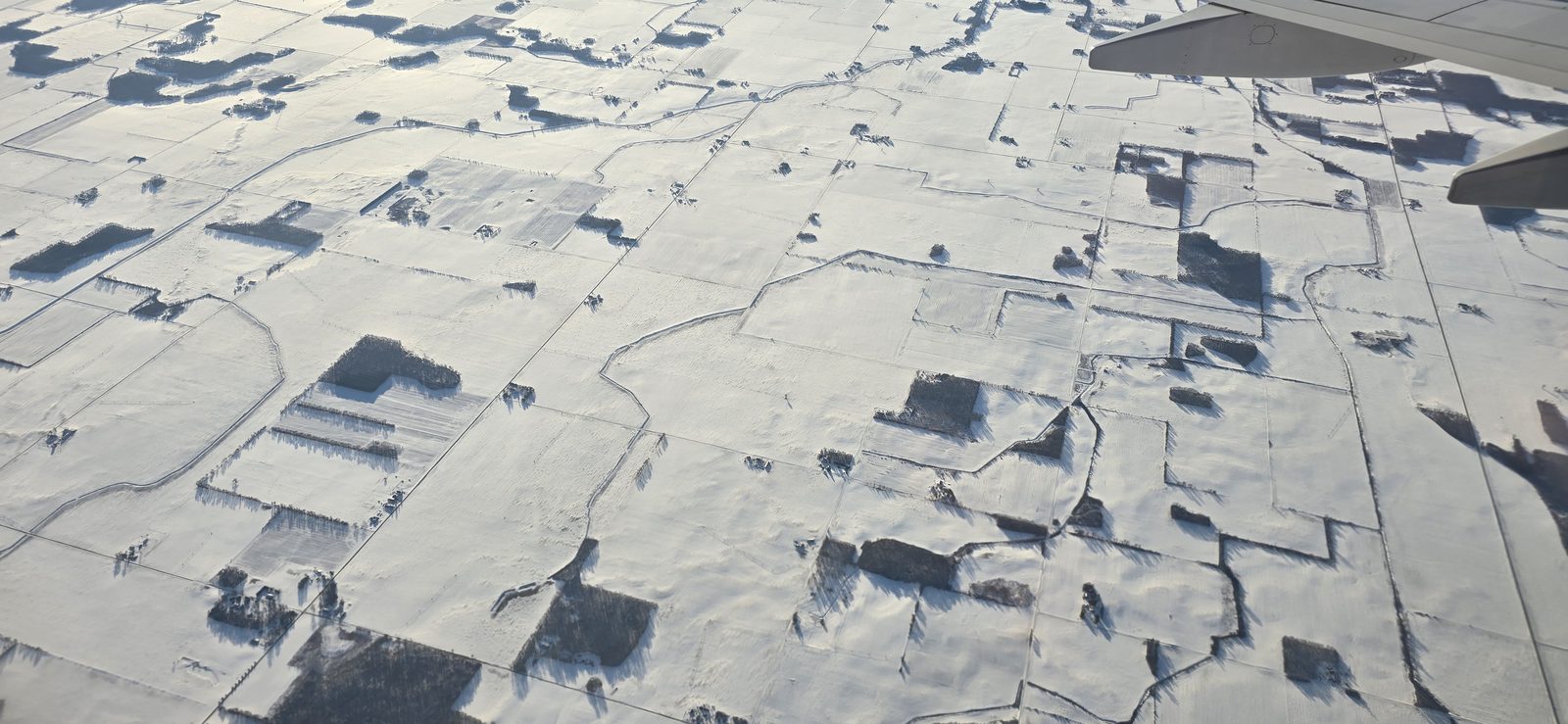 Snowy fields below as we flew home