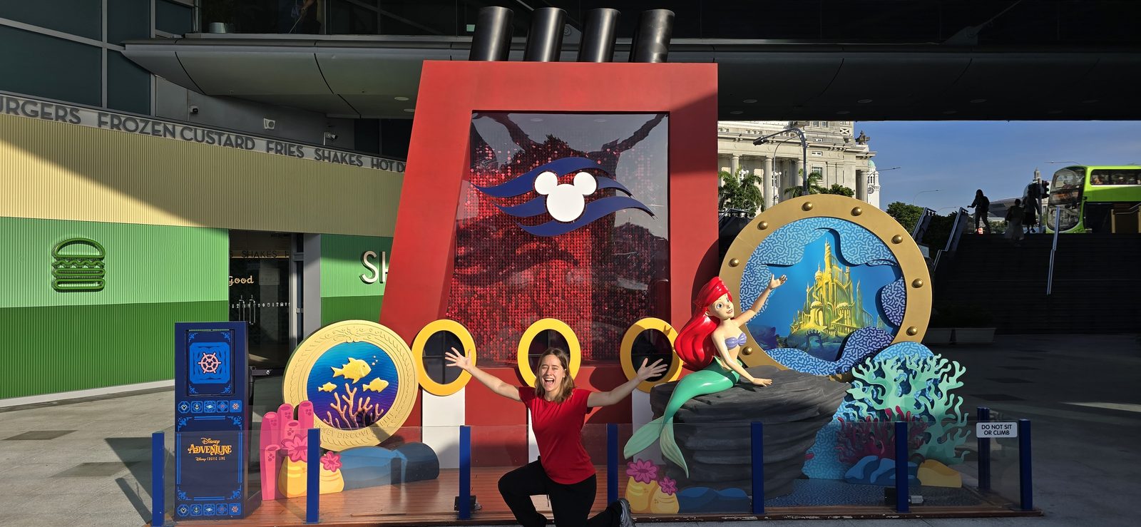 Lisa at the Disney Adventure welcome backdrop in Singapore