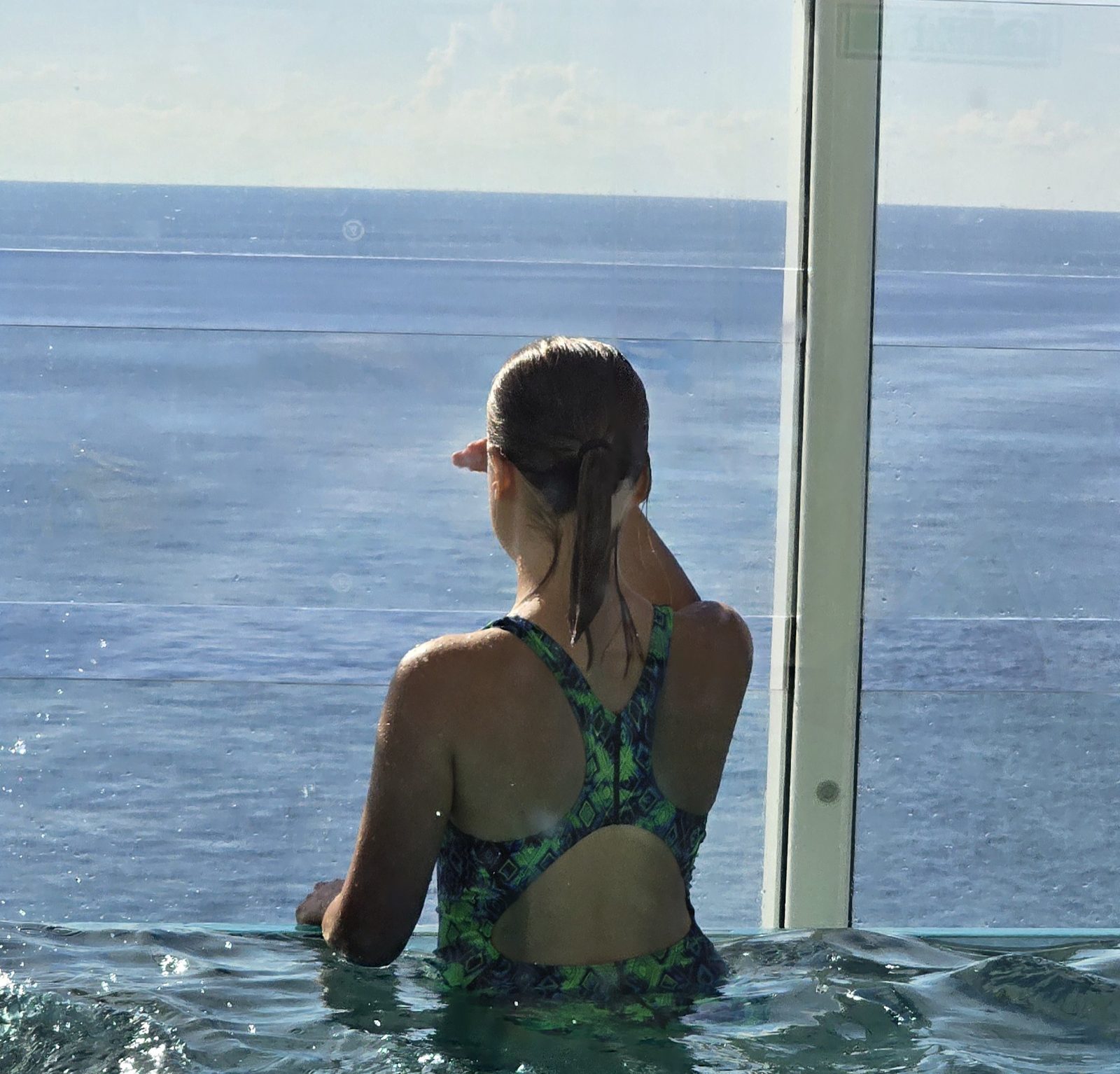 Lisa looking out to sea from the infinity pool