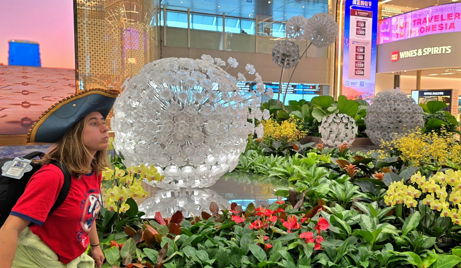 Lisa stopping to smell the flowers at Changi
