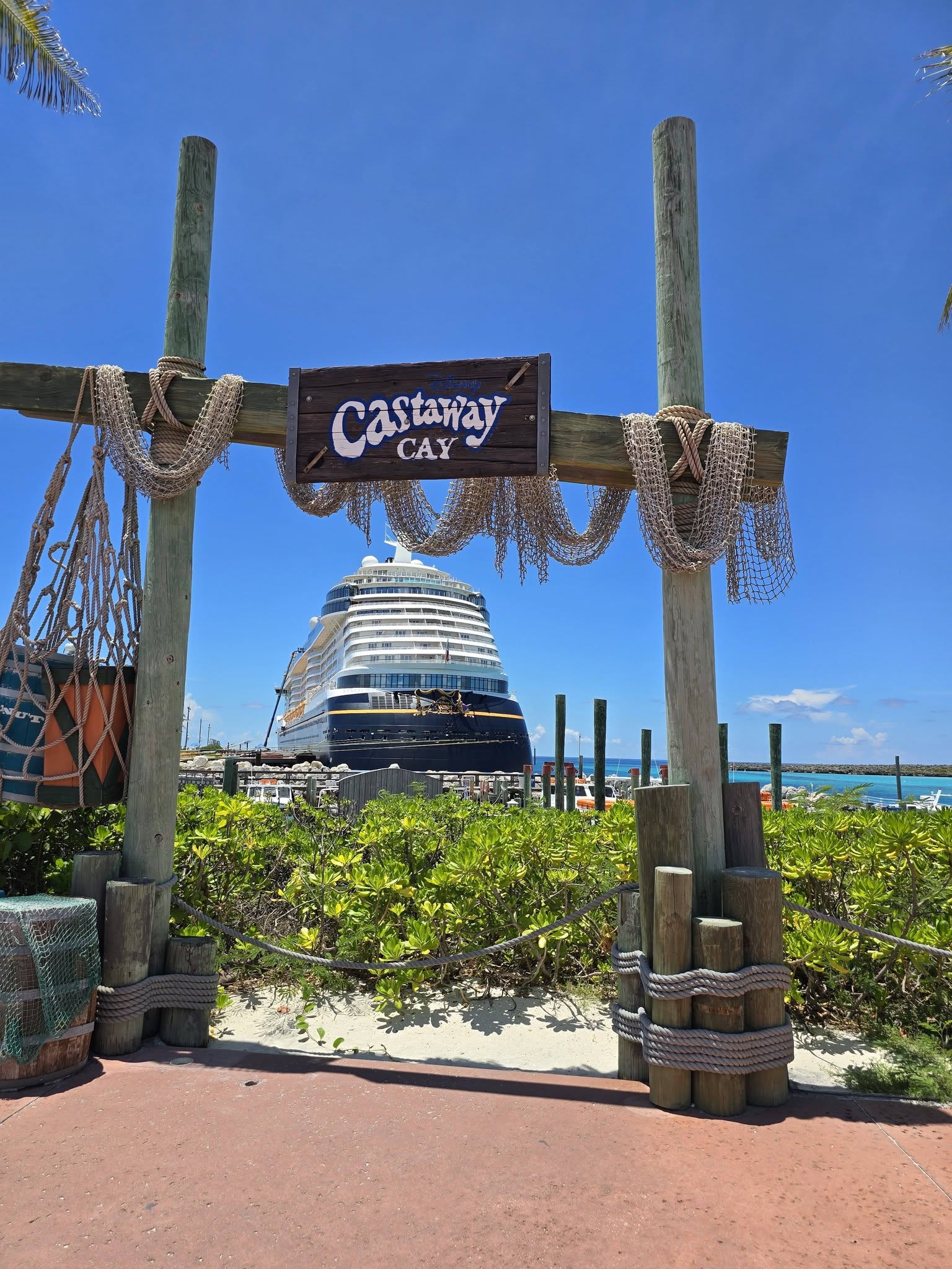 The Castaway Cay sign, with the Wish behind it