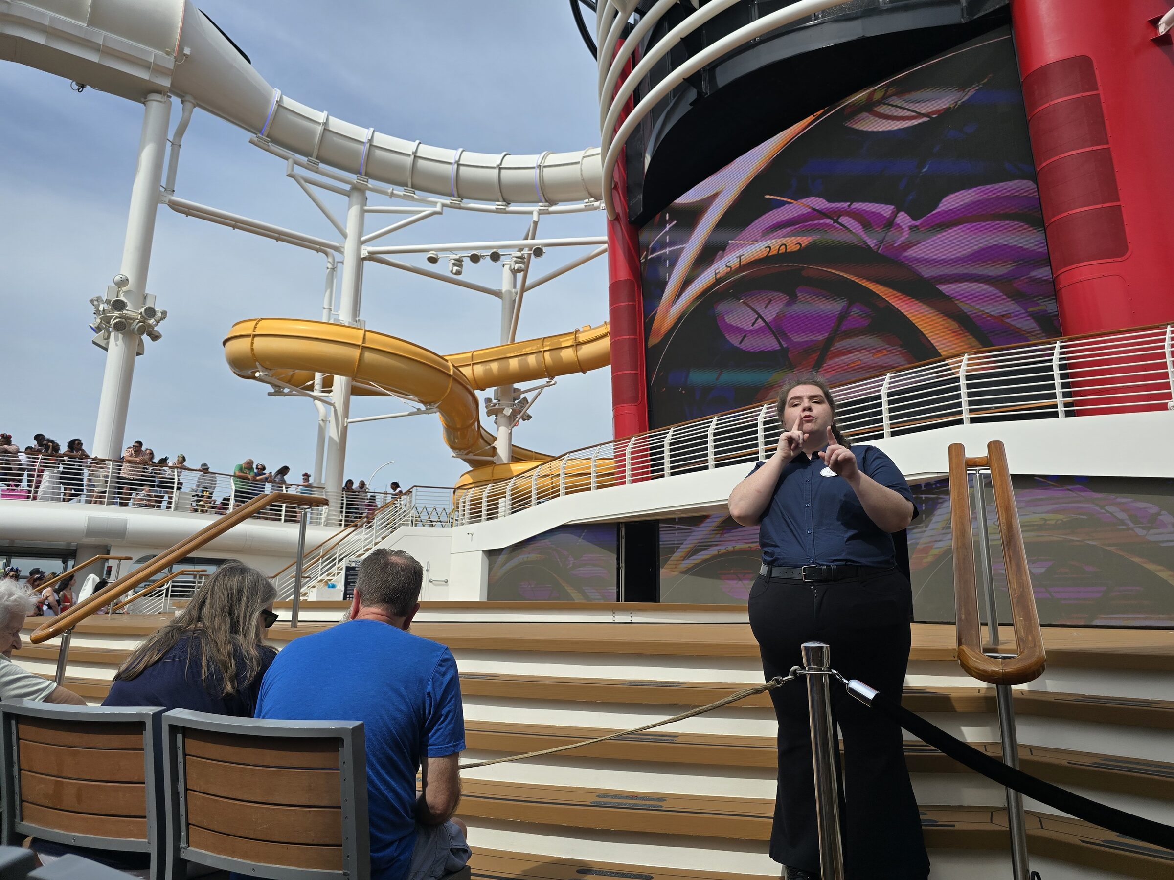 Kelly signing Let’s Set Sail on the Disney Wish pool deck