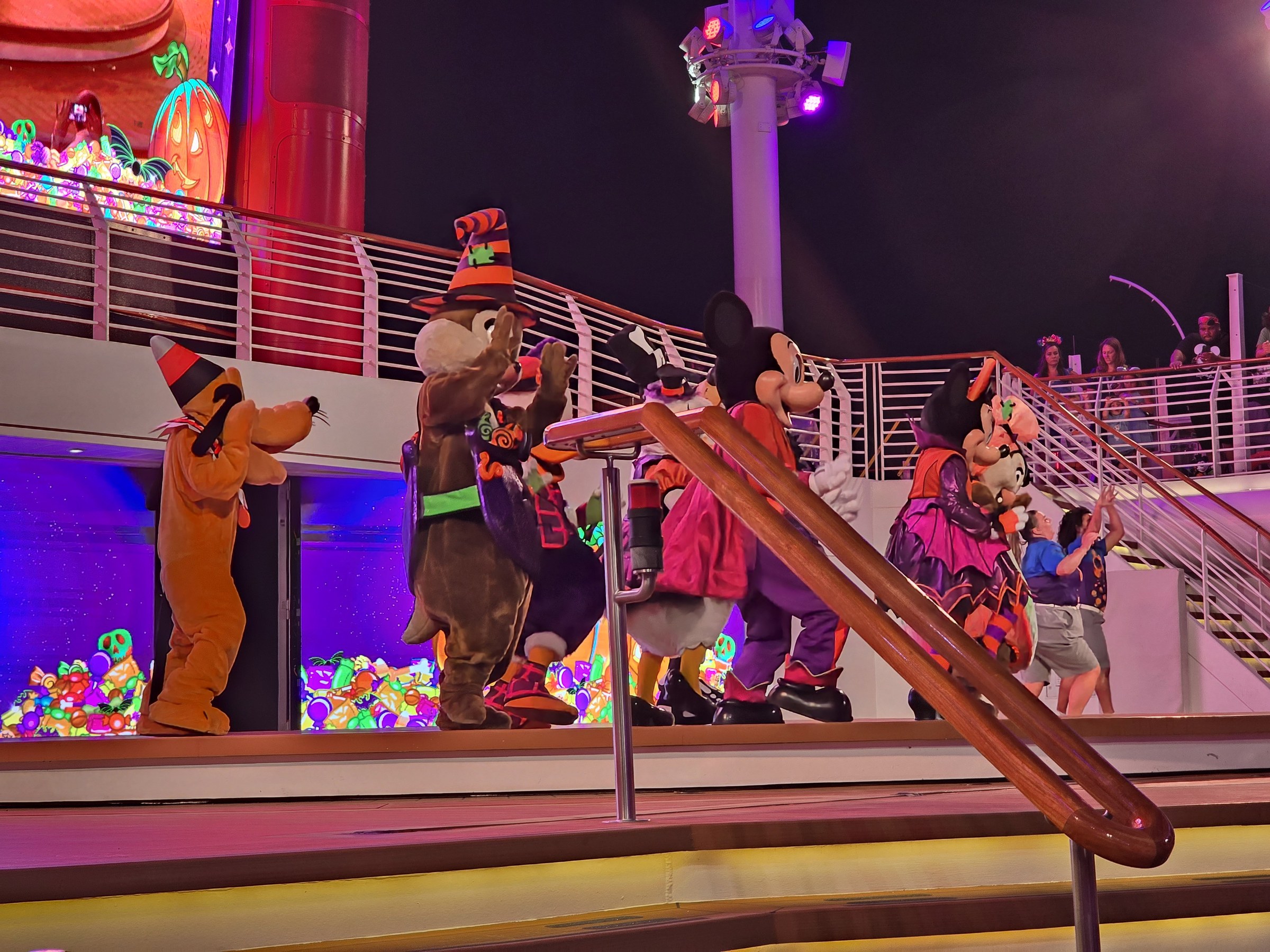 Pluto in his Halloween party hat with Chip, Mickey and Minnie in their Halloween costumes at Mickey's Mouse-Querade Party