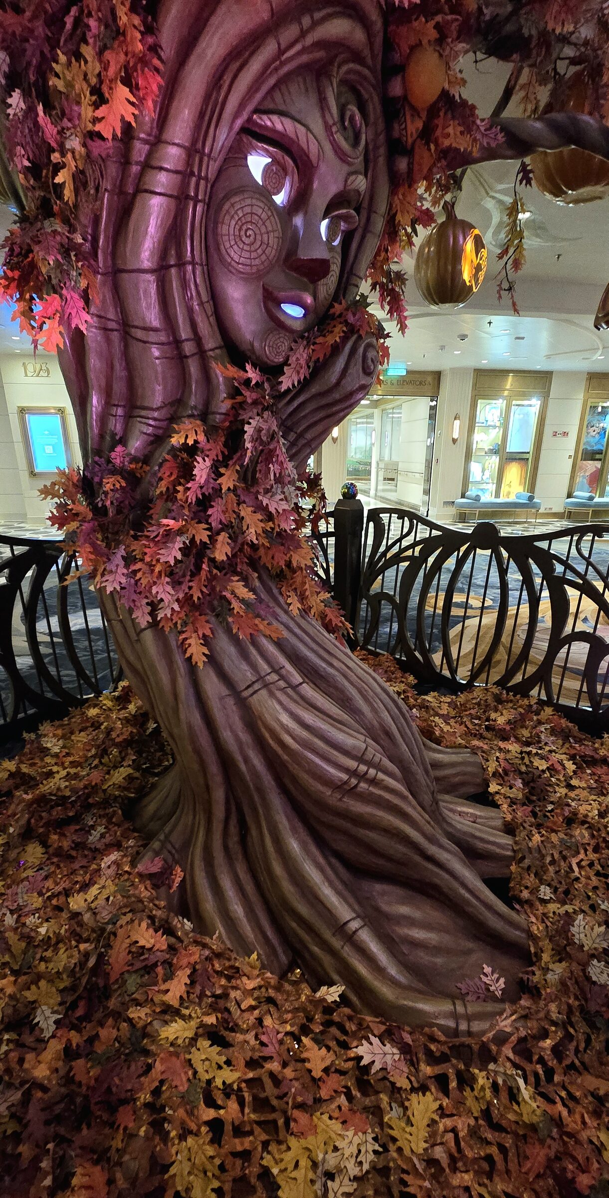 Boo the Pumpkin Tree's face among the fallen leaves in the Grand Hall