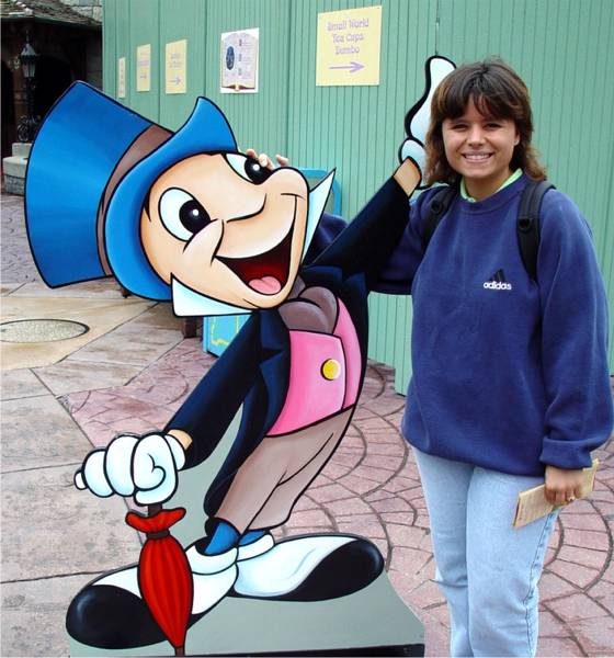 Kathy with a Jiminy Cricket cutout at Disneyland Paris