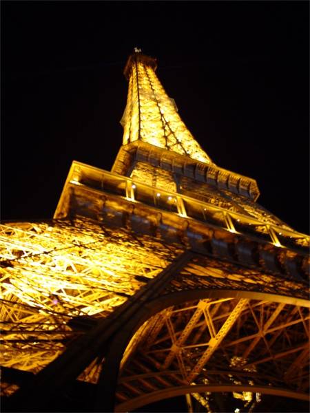 The Eiffel Tower's lattice lit up at night