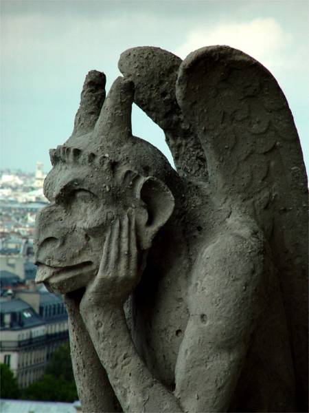 A gargoyle looking out from Notre-Dame