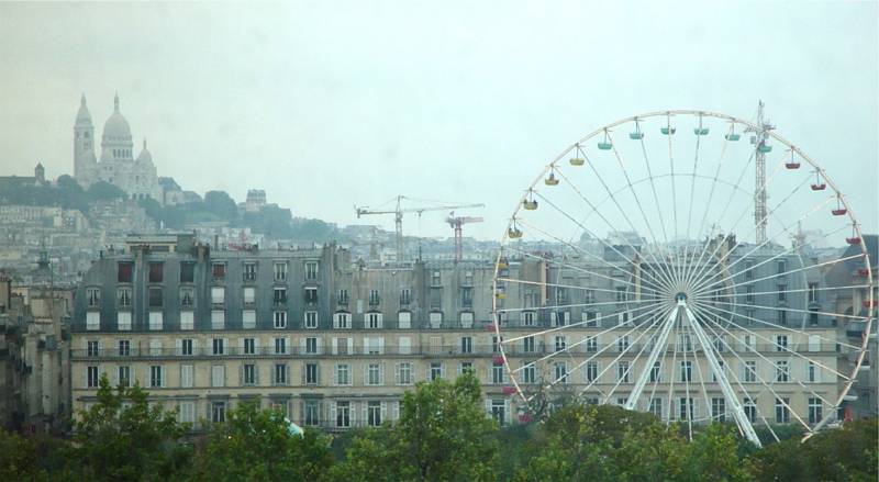 Sacre-Coeur and a Ferris wheel over Paris