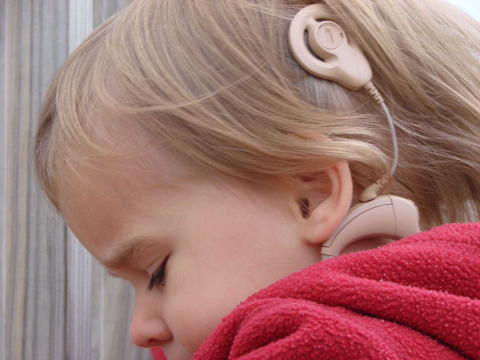 Lisa on the beach with her hearing aid