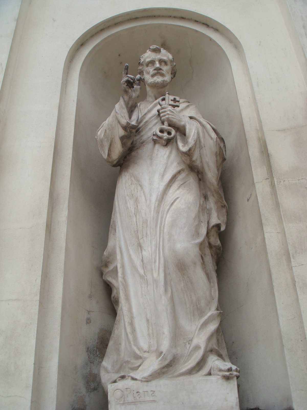 A statue set into a niche outside the church