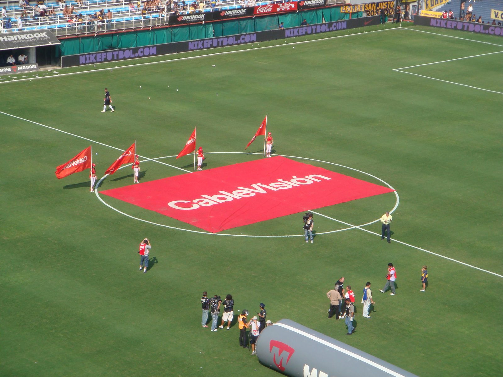 Flag bearers crossing the grass before kickoff