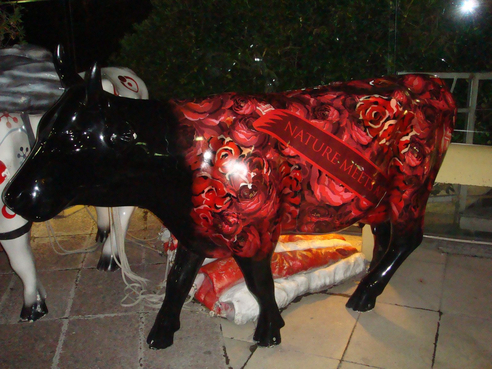 A painted cow statue outside the Hard Rock Cafe