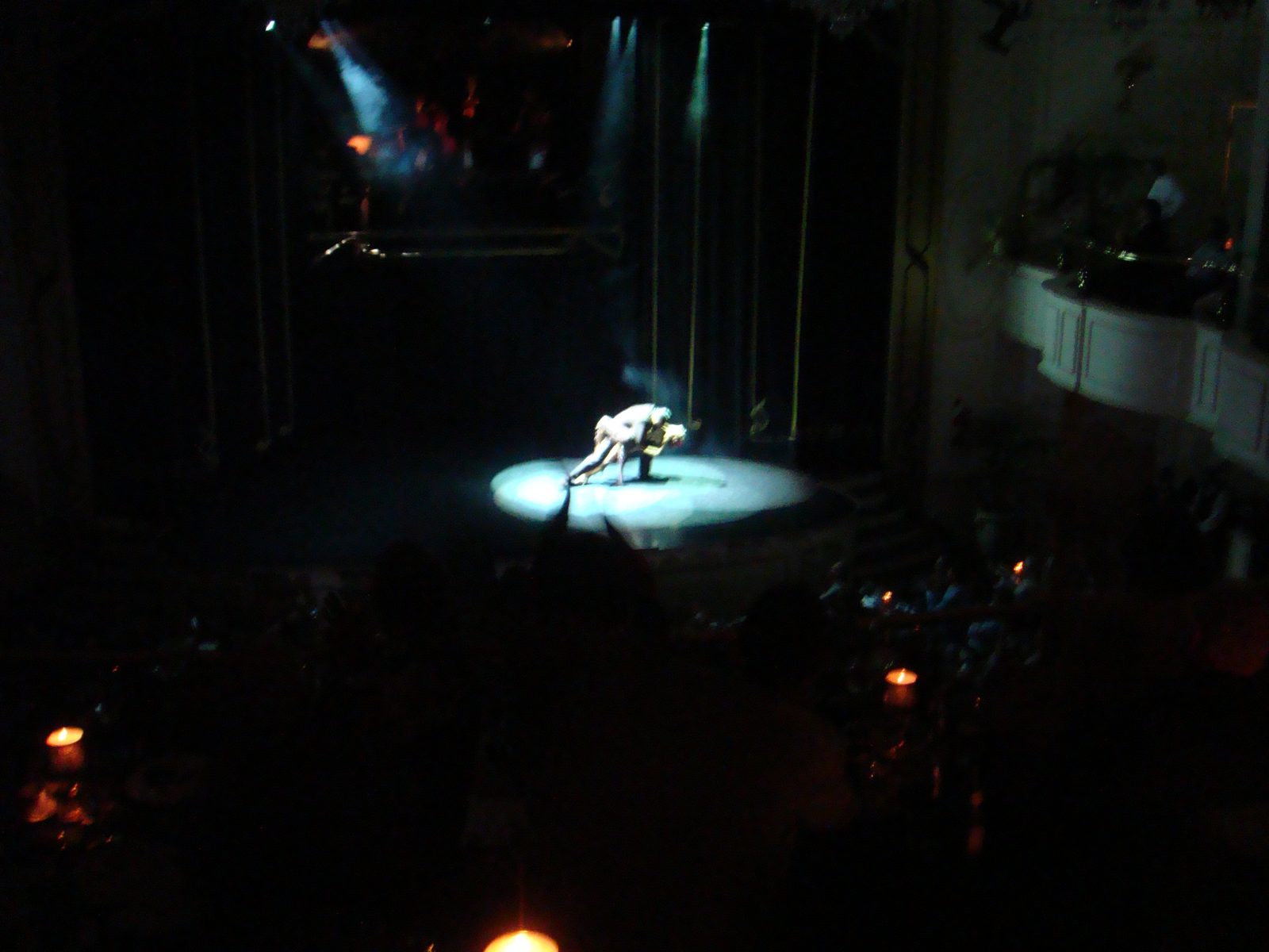 The tango couple under a single spotlight