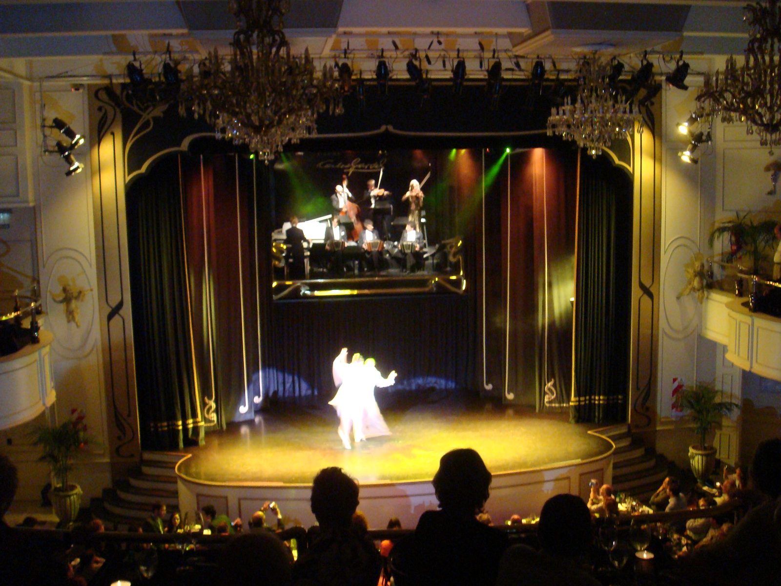 The tango couple turning and dipping across the stage